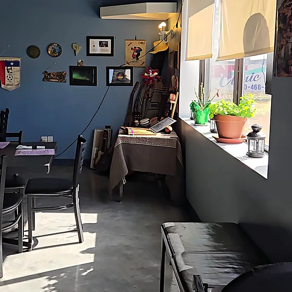 La Boca Loca dining room by the front window with plants and wall decor