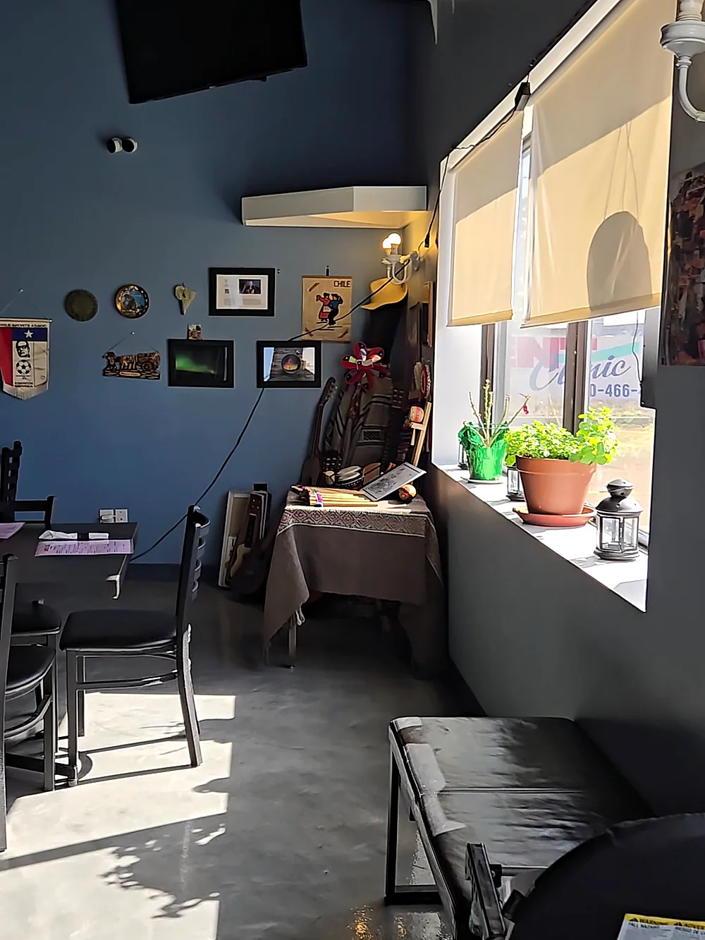 La Boca Loca dining room by the front window with plants and wall decor